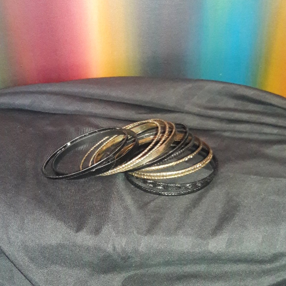 Gold & black bangle bracelets.